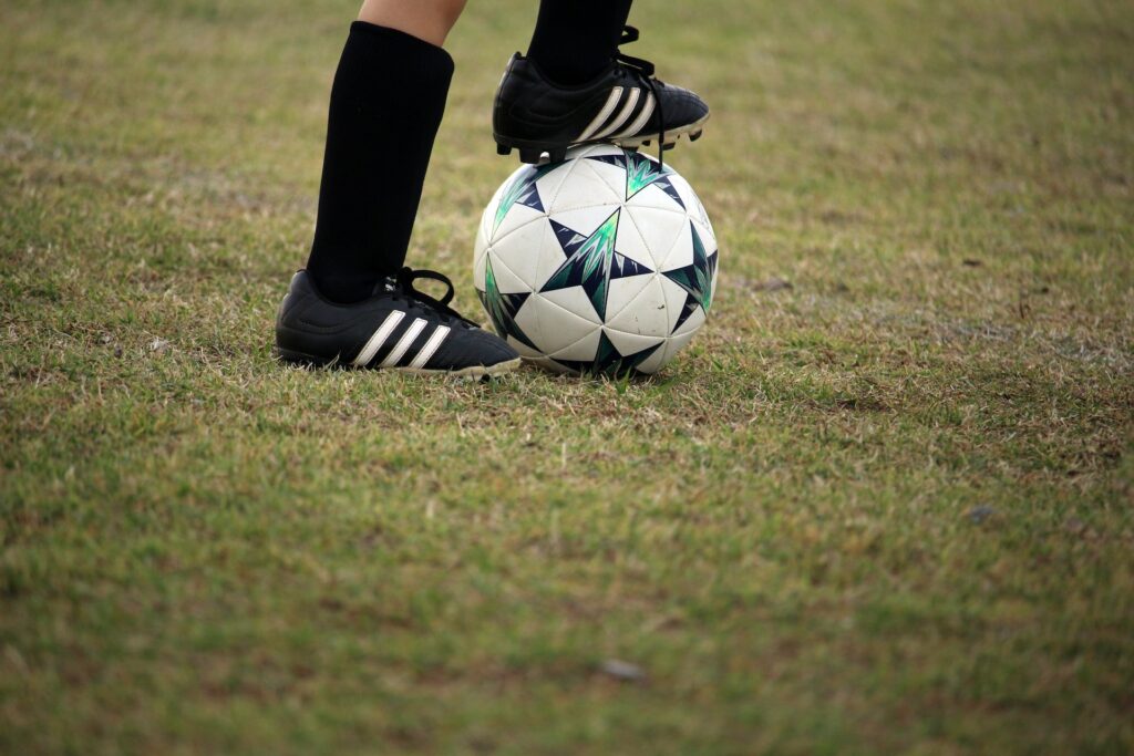 soccer player are going to kick the ball on the stadium