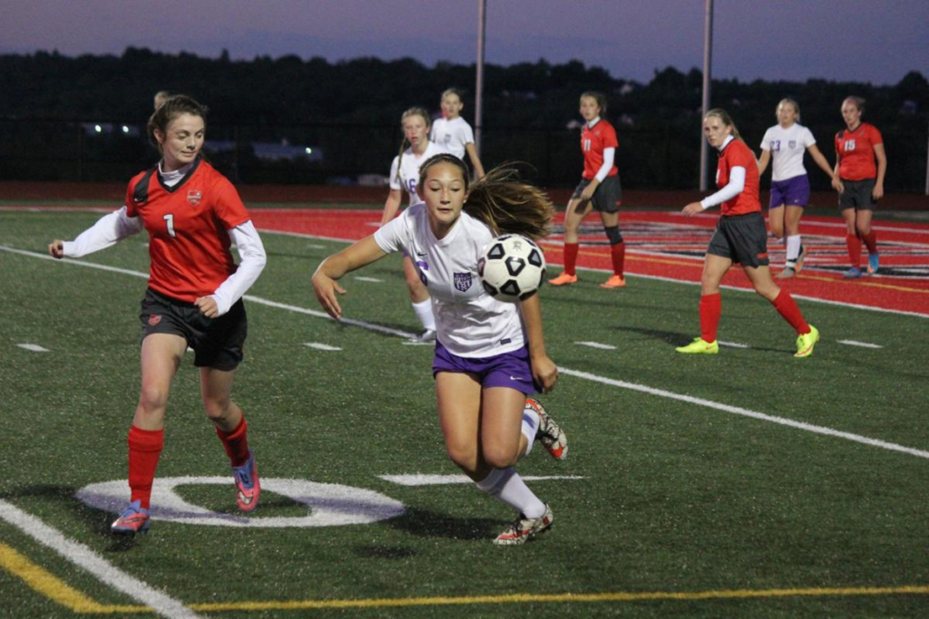 Teenagers play football