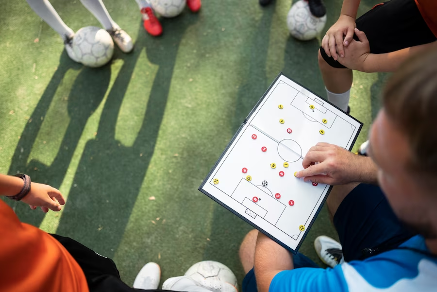 Football team and coach discussing strategy